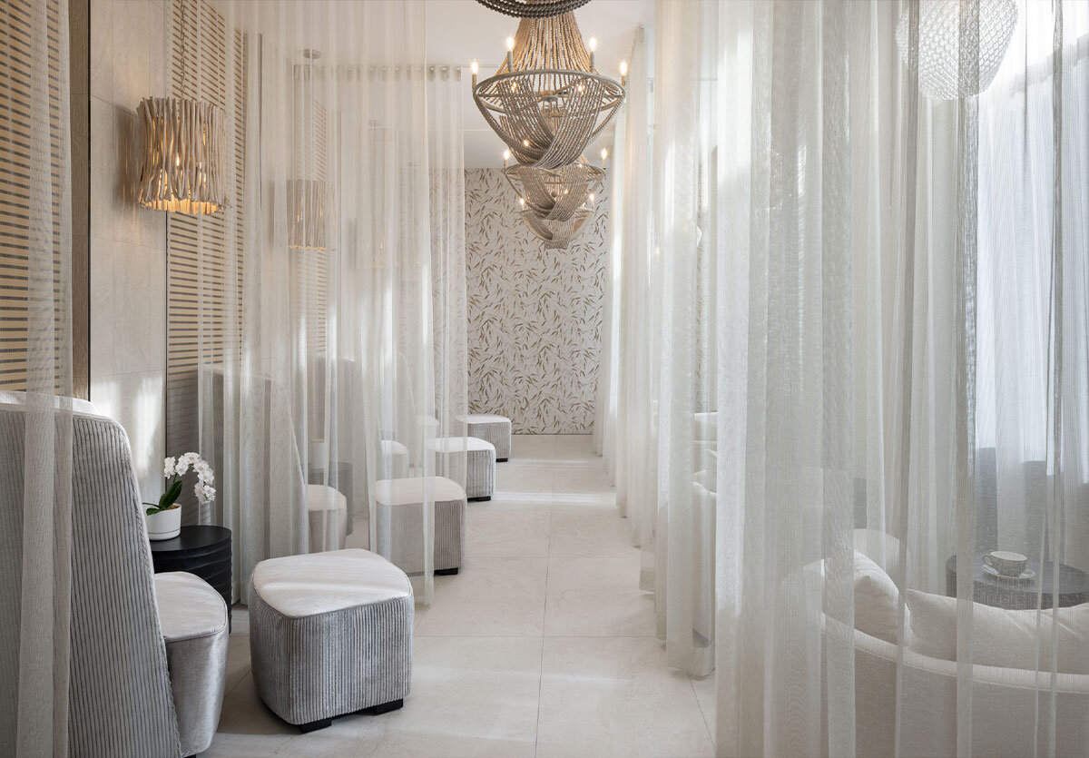 relaxing lounge space in the spa with sheer curtains and soft lighting